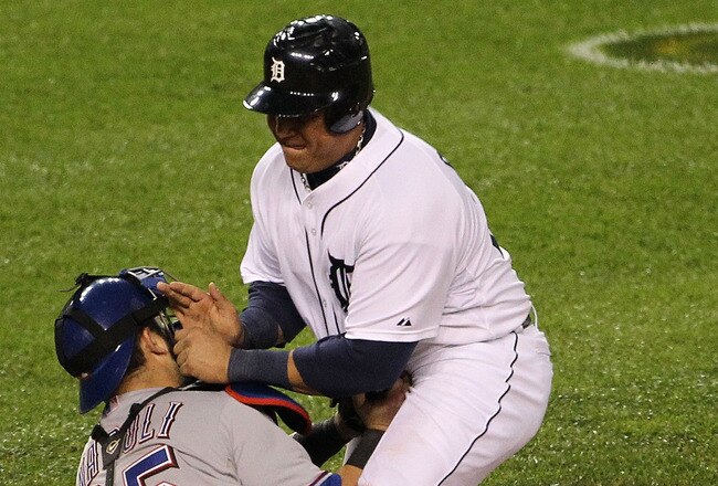 DETROIT, MI - OCTOBER 12:  Mike Napoli #25 of the Texas Rangers tags out Miguel Cabrera #24 of the Detroit Tigers at home plate for the final out of the eighth inning of Game Four of the American League Championship Series at Comerica Park on October 12, 2011 in Detroit, Michigan.  (Photo by Leon Halip/Getty Images)