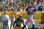 GREEN BAY, WI - OCTOBER 2: Brandon Lloyd #84 of the Denver Broncos makes a catch while being covered by Tramon Williams #38 of the Green Bay Packers at Lambeau Field on October 2, 2011 in Green Bay, Wisconsin. (Photo by Matt Ludtke /Getty Images)