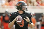 STILLWATER, OK - OCTOBER 8:  Quarterback Brandon Weeden #3 of Oklahoma State looks to throw in the first half against Kansas on October 8, 2011 at Boone Pickens Stadium in Stillwater, Oklahoma.  Oklahoma State defeated Kansas 70-28.  (Photo by Brett Deering/Getty Images)