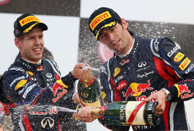 YEONGAM-GUN, SOUTH KOREA - OCTOBER 16:  Race winner Sebastian Vettel (L) of Germany and Red Bull Racing celebrates on the podium with third placed team mate Mark Webber of Australia and Red Bull Racing following the Korean Formula One Grand Prix at the Korea International Circuit on October 16, 2011 in Yeongam-gun, South Korea.  (Photo by Clive Mason/Getty Images)