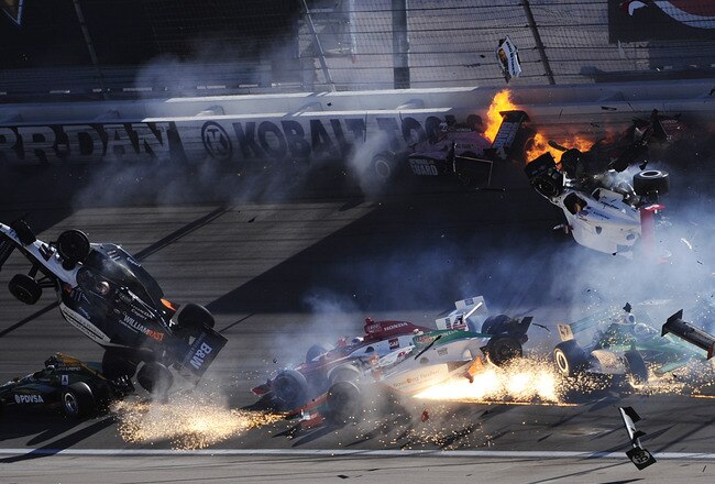 LAS VEGAS - OCTOBER 16:  The car of Dan Wheldon of England, driver of the #77 Bowers & Wilkins Sam Schmidt Motorsports Dallara Honda (left), and the #30 Rahal Letterman Lanigan Dallara Honda of Pippa Mann fly in the air during the Las Vegas Indy 300 part of the IZOD IndyCar World Championships presented by Honda on October 16, 2011 at the Las Vegas Motor Speedway in Las Vegas, Nevada.  (Photo by Robert Laberge/Getty Images)