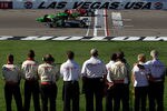 LAS VEGAS, NV - OCTOBER 16:  Team members line the pitlane as the drivers complete five memorial laps to honor Dan Wheldon, driver of the #77 Dallara Honda, who died of injuries in a massive fifteen car crash during the Las Vegas Indy 300 part of the IZOD IndyCar World Championships presented by Honda at Las Vegas Motor Speedway on October 16, 2011 in Las Vegas, Nevada.  (Photo by Tom Pennington/Getty Images)