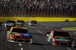 CHARLOTTE, NC - OCTOBER 15:  Matt Kenseth, driver of the #17 Fluidmaster Ford, passes Kyle Busch, driver of the #18 M&M's Toyota, for the lead in the NASCAR Sprint Cup Series Bank of America 500 at Charlotte Motor Speedway on October 15, 2011 in Charlotte, North Carolina.  (Photo by Chris Graythen/Getty Images)