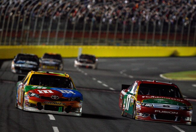 CHARLOTTE, NC - OCTOBER 15:  Matt Kenseth, driver of the #17 Fluidmaster Ford, passes Kyle Busch, driver of the #18 M&M's Toyota, for the lead in the NASCAR Sprint Cup Series Bank of America 500 at Charlotte Motor Speedway on October 15, 2011 in Charlotte, North Carolina.  (Photo by Chris Graythen/Getty Images)