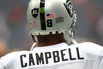 HOUSTON, TX - OCTOBER 09:  Quarterback Jason Campbell #8 of  the Oakland Raiders who is wearing a Black AL in the form of a Raider shield on the back of helmet warms up before playing against the Houston Texans on October 9, 2011 at Reliant Stadium in Houston, Texas. Raider owner, Al Davis died at age 82 at his home Saturday morning.  (Photo by Thomas B. Shea/Getty Images)