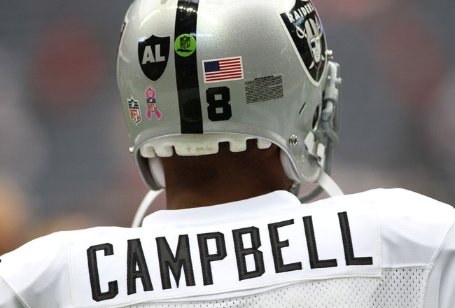 HOUSTON, TX - OCTOBER 09:  Quarterback Jason Campbell #8 of  the Oakland Raiders who is wearing a Black AL in the form of a Raider shield on the back of helmet warms up before playing against the Houston Texans on October 9, 2011 at Reliant Stadium in Houston, Texas. Raider owner, Al Davis died at age 82 at his home Saturday morning.  (Photo by Thomas B. Shea/Getty Images)