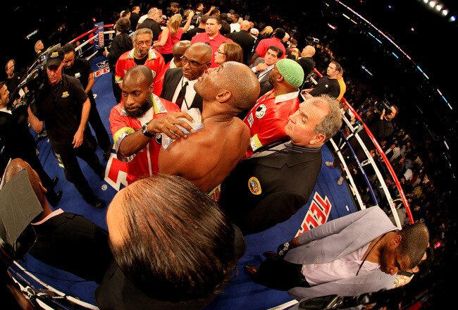 LOS ANGELES, CA - OCTOBER 15:  Bernard Hopkins (center) watches a video replay of his fall and shoulder injury against Chad Dawsonas ice is applied to his injury after their WBC and Ring Magzine light heavyweight title fight at Staples Center on October 15, 2011 in Los Angeles, California. Hopkins was unable to continue as Dawson was awarded a second round TKO.  (Photo by Stephen Dunn/Getty Images)