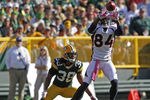 GREEN BAY, WI - OCTOBER 2: Brandon Lloyd #84 of the Denver Broncos makes a catch while being covered by Tramon Williams #38 of the Green Bay Packers at Lambeau Field on October 2, 2011 in Green Bay, Wisconsin. (Photo by Matt Ludtke /Getty Images)
