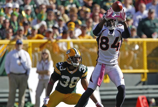 GREEN BAY, WI - OCTOBER 2: Brandon Lloyd #84 of the Denver Broncos makes a catch while being covered by Tramon Williams #38 of the Green Bay Packers at Lambeau Field on October 2, 2011 in Green Bay, Wisconsin. (Photo by Matt Ludtke /Getty Images)