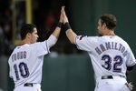 ARLINGTON, TX - OCTOBER 15:  Michael Young #10 and Josh Hamilton #32 of the Texas Rangers celebrate a 9-2 lead at the end of the third inning of Game Six of the American League Championship Series against the Detroit Tigers at Rangers Ballpark in Arlington on October 15, 2011 in Arlington, Texas.  (Photo by Harry How/Getty Images)
