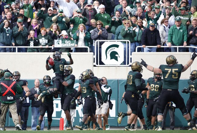 EAST LANSING, MI - OCTOBER 15: Isaiah Lewis #9 of the Michigan State Spartans celebrates a 39 yard touchdown after intercepting a pass from Denard Robinson #9 of the Michigan Wolverines in the fourth quarter of the game at Spartan Stadium on October 15, 2011 in East Lansing, Michigan. Michigan State defeated Michigan 28-14. (Photo by Leon Halip/Getty Images)