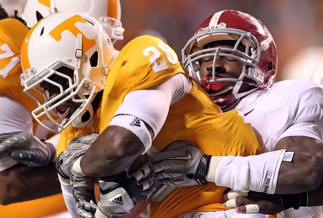 KNOXVILLE, TN - OCTOBER 23:  Tauren Poole #28 of the Tennessee Volunteers runs with the ball dwhile tackled by C.J. Mosley #32 of the Alabama Crimson Tide at Neyland Stadium on October 23, 2010 in Knoxville, Tennessee.  (Photo by Andy Lyons/Getty Images)