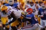 BATON ROUGE, LA - OCTOBER 08:  Deangelo Peterson #19 of the Louisiana State University Tigers is tackled by Matt Elam #22 of the Florida Gators at Tiger Stadium on October 8, 2011 in Baton Rouge, Louisiana.  (Photo by Chris Graythen/Getty Images)