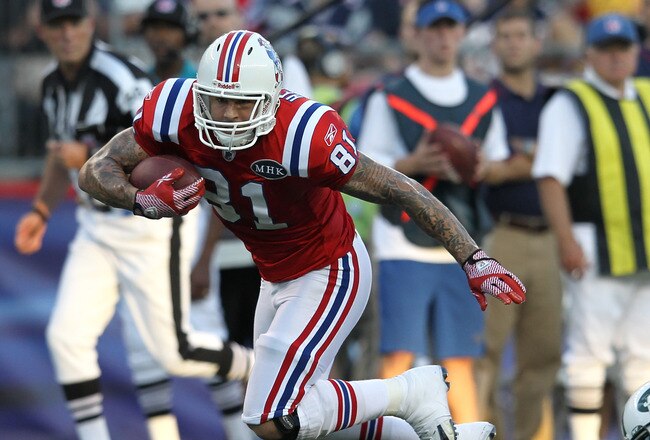 FOXBORO, MA - OCTOBER 9:   Aaron Hernandez #81 of the New England Patriots gains yards as Donald Strickland #30 of the New York Jets defends in the second half at Gillette Stadium on October 9, 2011 in Foxboro, Massachusetts. (Photo by Jim Rogash/Getty Images)
