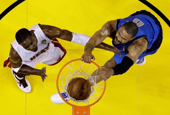 MIAMI, FL - JUNE 12:  Tyson Chandler #6 of the Dallas Mavericks dunks against Chris Bosh #1 of the Miami Heat in Game Six of the 2011 NBA Finals at American Airlines Arena on June 12, 2011 in Miami, Florida. NOTE TO USER: User expressly acknowledges and agrees that, by downloading and/or using this Photograph, user is consenting to the terms and conditions of the Getty Images License Agreement.  (Photo by David J. Phillip-Pool/Getty Images)