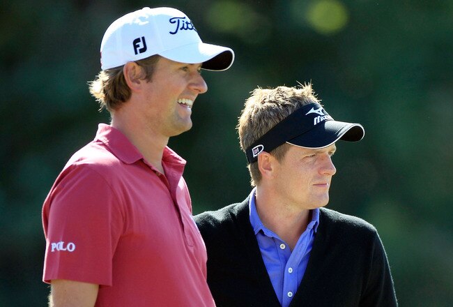 LAKE BUENA VISTA, FL - OCTOBER 20:  Webb Simpson (L) and Luke Donald of England wait to play a shot on the 18th hole during the first round of the Children's Miracle Network Classic at the Disney Palm and Magnolia course on October 20, 2011 in Lake Buena Vista, Florida.  (Photo by Sam Greenwood/Getty Images)