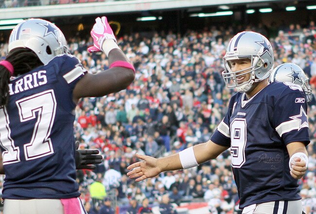 FOXBORO, MA - OCTOBER 16:  Tony Romo #9 of the Dallas Cowboys celebrates the touchdown with teammate  Dwayne Harris #17 in the first half against the New England Patriots on October 16, 2011 at Gillette Stadium in Foxboro, Massachusetts.  (Photo by Elsa/Getty Images)
