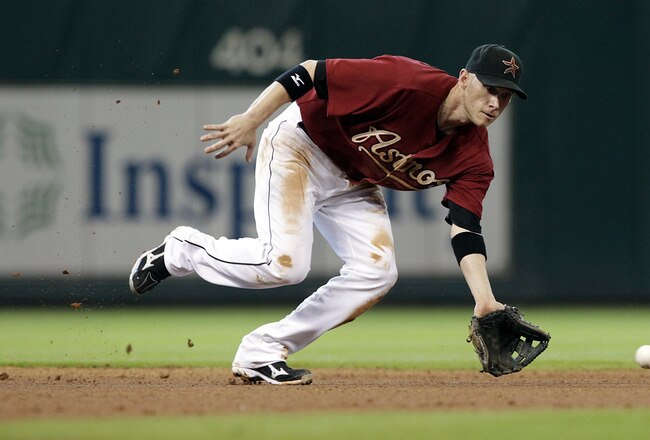 HOUSTON - SEPTEMBER 25:  Shorstop Clint Barmes #12 of the Houston Astros fields a ground ball against the Colorado Rockies at Minute Maid Park on September 25, 2011 in Houston, Texas.  (Photo by Bob Levey/Getty Images)