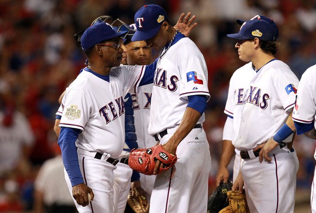 ARLINGTON, TX - OCTOBER 22:  Alexi Ogando #41 of the Texas Rangers is removed from the game in the sixth inning by manager Ron Washington during Game Three of the MLB World Series against the St. Louis Cardinals at Rangers Ballpark in Arlington on October 22, 2011 in Arlington, Texas.  (Photo by Ronald Martinez/Getty Images)