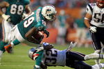MIAMI GARDENS, FL - SEPTEMBER 12:  Reciever Brandon Marshall #19 of the Miami Dolphins is brought down by cornerback Devin McCourty #32 of the New England Patriots at Sun Life Stadium on September 12, 2011 in Miami Gardens, Florida.  (Photo by Marc Serota/Getty Images)