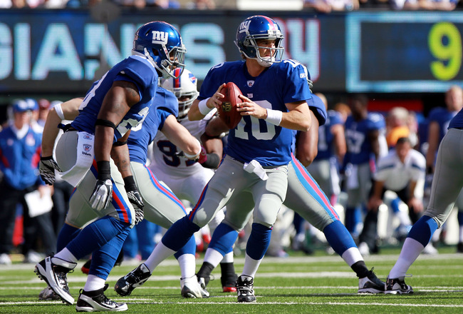 EAST RUTHERFORD, NJ - OCTOBER 16: Eli Manning #10 of the New York Giants looks to pass against the Buffalo Bills at MetLife Stadium on October 16, 2011 in East Rutherford, New Jersey.  (Photo by Nick Laham/Getty Images)