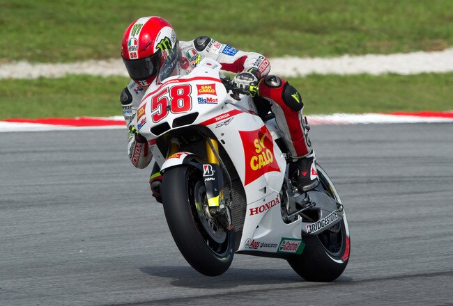 KUALA LUMPUR, MALAYSIA - OCTOBER 22:  Marco Simoncelli of Italy and San Carlo Honda Gresini lifts the front wheel during the qualifying practice of MotoGP of Malaysia at Sepang Circuit on October 22, 2011 in Kuala Lumpur, Malaysia.  (Photo by Mirco Lazzari gp/Getty Images)