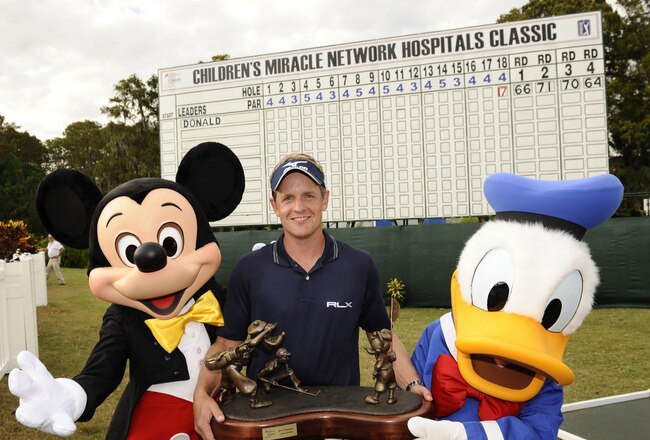 LAKE BUENA VISTA, FL - OCTOBER 23:  In this handout image provided by Disney Parks, Luke Donald, winner of the 2011 Children's Miracle Network Hospitals Classic at Walt Disney World Resort in Lake Buena Vista, Florida, poses on October 23, 2011 with Mickey Mouse and Donald Duck following his win at Disney's Magnolia Golf Course.  Donald, the world's top-ranked player, shot a -17 for the tournament to win the 41st annual PGA TOUR event at Walt Disney World.  He shot six straight birdies Sunday to come from five shots behind and capture the tournament title. The season finale win also secured Donald the PGA TOUR money title for 2011. (Photo by Preston Mack/Disney Parks via Getty Images)
