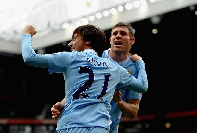 MANCHESTER, ENGLAND - OCTOBER 23: David Silva and James Milner of Manchester City celebrate during the Barclays Premier League match between Manchester United and Manchester City at Old Trafford on October 23, 2011 in Manchester, England. (Photo by Laurence Griffiths/Getty Images)