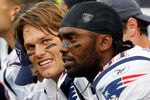 FOXBORO, MA - SEPTEMBER 12: Quarterback Tom Brady #12 and Randy Moss #81 of the New England Patriots take a breather on the bench during the NFL season opener against the Cincinnati Bengals at Gillette Stadium on September 12, 2010 in Foxboro, Massachusetts. (Photo by Jim Rogash/Getty Images)