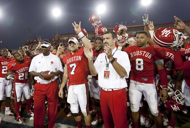 HOUSTON - OCTOBER 22:  Head coach Kevin Sumlin (L) hands quarterback Case Keenum #7, the game ball, as athletic director Mack Rhoades looks on at Robertson Stadium on October 22, 2011 in Houston, Texas. Keenum broke the NCAA career total offensive record against the Marshall Thundering Herd.  (Photo by Bob Levey/Getty Images)