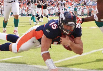 MIAMI GARDENS, FL - OCTOBER 23:  Quarterback Tim Tebow #15 of the Denver Broncos dives against the Miami Dolphins to end the game to overtime at Sun Life Stadium on October 23, 2011 in Miami Gardens, Florida. Denver defeated Miami 18-15.  (Photo by Marc Serota/Getty Images)