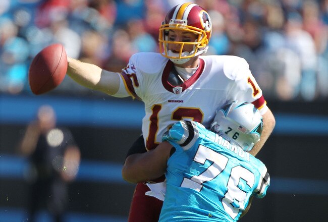 CHARLOTTE, NC - OCTOBER 23:  John Beck #12 of the Washington Redskins is sacked by Greg Hardy #76 of the Carolina Panthers during their game at Bank of America Stadium on October 23, 2011 in Charlotte, North Carolina.  (Photo by Scott Halleran/Getty Images)