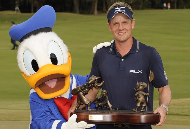 LAKE BUENA VISTA, FL - OCTOBER 23:  In this handout image provided by Disney Parks, Luke Donald, winner of the 2011 Children's Miracle Network Hospitals Classic at Walt Disney World Resort in Lake Buena Vista, Florida, poses on October 23, 2011 with Donald Duck following his win at Disney's Magnolia Golf Course.  Donald, the world's top-ranked player, shot a -17 for the tournament to win the 41st annual PGA TOUR event at Walt Disney World.  He shot six straight birdies Sunday to come from five shots behind and capture the tournament title. The season finale win also secured Donald the PGA TOUR money title for 2011. (Photo by Preston Mack/Disney Parks via Getty Images)