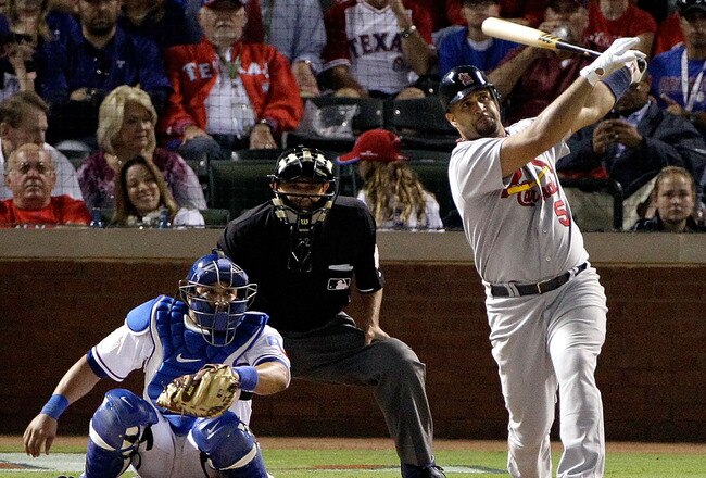 ARLINGTON, TX - OCTOBER 22:  Albert Pujols #5 of the St. Louis Cardinals hits a solo home run in the ninth inning for his third home run of the night during Game Three of the MLB World Series against pitcher Darren Oliver of the Texas Rangers at Rangers Ballpark in Arlington on October 22, 2011 in Arlington, Texas.  (Photo by Rob Carr/Getty Images)