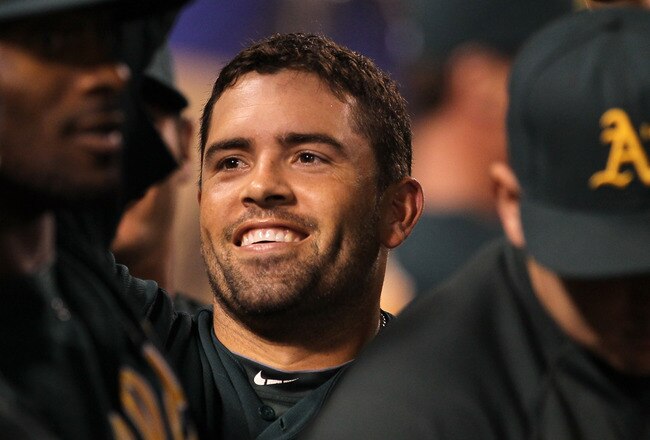 ANAHEIM, CA - SEPTEMBER 23:  David Dejesus #12 of the Oakland Athletics celebrates in the dugout after hitting a solo home run in the ninth inning against the Los Angeles Angels of Anaheim on September 23, 2011 at Angel Stadium in Anaheim, California.   (Photo by Stephen Dunn/Getty Images)