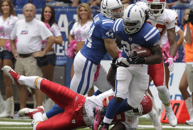 INDIANAPOLIS, IN - OCTOBER 9: Joseph Addai #29, of the Indianapolis Colts  fights to break free from Jovan Belcher #59 of the Kansas City Chiefs during the first half of play at Lucas Oil Field on October 9, 2011 in Indianapolis, Indiana. The Chiefs won 28-24.  (Photo by John Sommers II/Getty Images)
