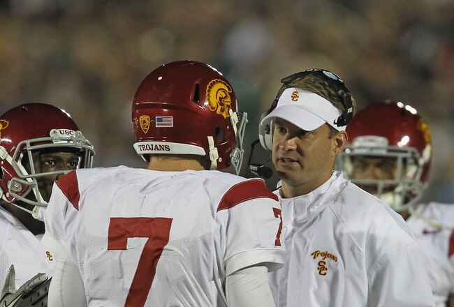 SOUTH BEND, IN - OCTOBER 22: Head coach Lane Kiffin of the University of Southern California Trojans talks with Matt Barkley #7 during a time-out against the Notre Dame Fighting Irish at Notre Dame Stadium on October 22, 2011 in South Bend, Indiana. (Photo by Jonathan Daniel/Getty Images)