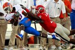 JACKSONVILLE, FL - OCTOBER 30:  Chris Rainey #3 of the Florida Gators is sent out of bounds by Alec Ogletree #9 of the Georgia Bulldogs during the game at EverBank Field on October 30, 2010 in Jacksonville, Florida.  (Photo by Sam Greenwood/Getty Images)