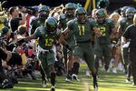 EUGENE, OR - OCTOBER 2: Cornerback Cliff Harris #13  and rover Eddie Pleasant #11 of the Oregon Ducks lead the team onto the field for the game against the Stanford Cardinal at Autzen Stadium on October 2, 2010 in Eugene, Oregon. Oregon won the game 52-31. (Photo by Steve Dykes/Getty Images)