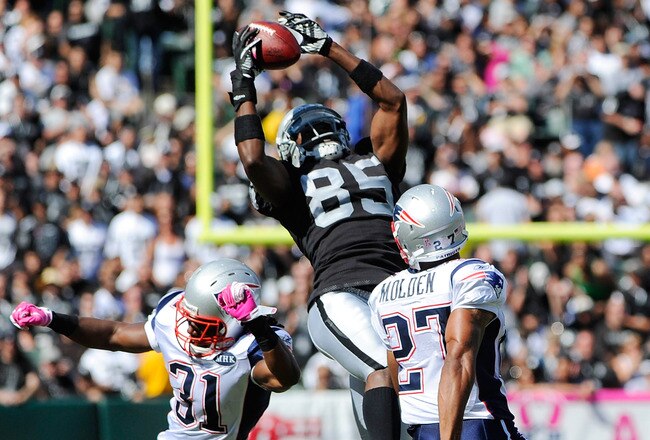 OAKLAND, CA - OCTOBER 02: Darrius Heyward-Bey #85 of the Oakland Raiders catches this pass over Sergio Brown #31 and Antwaun Molden #27 of the New England Patriots during an NFL football game at O.co Coliseum on October 2, 2011 in Oakland, California.  (Photo by Thearon W. Henderson/Getty Images)