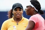 EASTBOURNE, ENGLAND - JUNE 11:  Serena Williams (L) of the USA chats to her sister Venus during a break in practice for the AEGON International on June 11, 2011 in Eastbourne, England.  (Photo by Bryn Lennon/Getty Images)