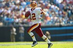 CHARLOTTE, NC - OCTOBER 23: John Beck #12 of the Washington Redskins scrambles against the Washington Redskins at the Bank of America Stadium on October 23, 2011 in Charlotte, North Carolina.  (Photo by Dilip Vishwanat/Getty Images)