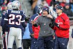FOXBORO, MA - JANUARY 10:  Head coach Bill Belichick (C) and defensive backs coach Josh Boyer (R) of the New England Patriots talk with Leigh Bodden #23 against the Baltimore Ravens during the 2010 AFC wild-card playoff game at Gillette Stadium on January 10, 2010 in Foxboro, Massachusetts.  (Photo by Jim Rogash/Getty Images)