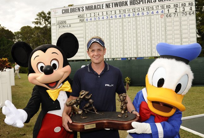 LAKE BUENA VISTA, FL - OCTOBER 23:  In this handout image provided by Disney Parks, Luke Donald, winner of the 2011 Children's Miracle Network Hospitals Classic at Walt Disney World Resort in Lake Buena Vista, Florida, poses on October 23, 2011 with Mickey Mouse and Donald Duck following his win at Disney's Magnolia Golf Course.  Donald, the world's top-ranked player, shot a -17 for the tournament to win the 41st annual PGA TOUR event at Walt Disney World.  He shot six straight birdies Sunday to come from five shots behind and capture the tournament title. The season finale win also secured Donald the PGA TOUR money title for 2011. (Photo by Preston Mack/Disney Parks via Getty Images)