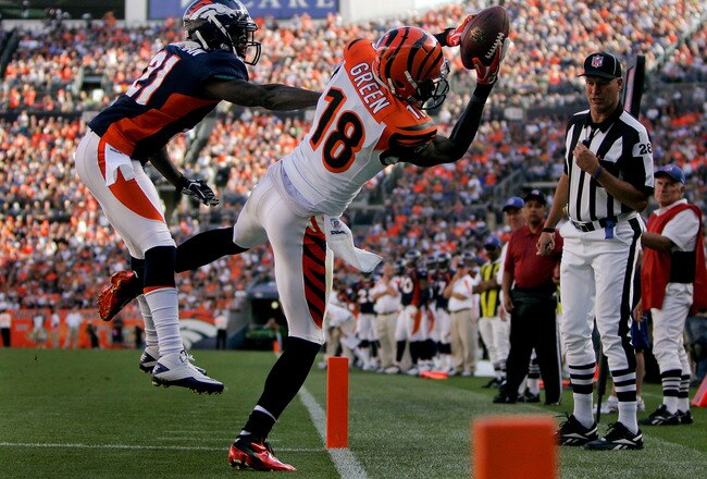 DENVER, CO - SEPTEMBER 18:  Wide receiver A.J. Green #18 of the Cincinnati Bengals makes a catch for a touchdown as Cornerback Andre' Goodman #21 of the Denver Broncos defends during the fourth quarter at Sports Authority Field at Mile High on September 18, 2011 in Denver, Colorado. (Photo by Justin Edmonds/Getty Images)