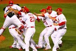 ST LOUIS, MO - OCTOBER 28:  Yadier Molina #4, Gerald Laird #13 and David Freese #23 of the St. Louis Cardinals celebrate after defeating the Texas Rangers 6-2 to win the World Series in Game Seven of the MLB World Series at Busch Stadium on October 28, 2011 in St Louis, Missouri.  (Photo by Dilip Vishwanat/Getty Images)