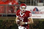 HOUSTON - OCTOBER 27:  Quarterback Case Keenum #7 of the Houston Cougars rolls out as he looks for a receiver in the third quarter against the Rice Owls at Robertson Stadium on October 27, 2011 in Houston, Texas.  Houston wo 73-34.(Photo by Bob Levey/Getty Images)