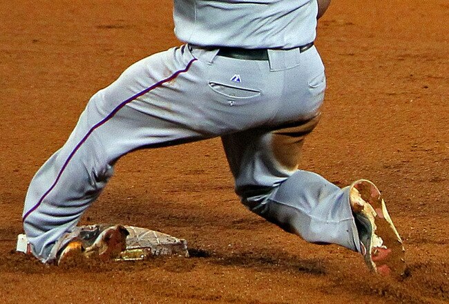 ST LOUIS, MO - OCTOBER 27:  Mike Napoli #25 of the Texas Rangers rolls his ankle sliding into second base after a throwing error in the fourth inning during Game Six of the MLB World Series at Busch Stadium on October 27, 2011 in St Louis, Missouri.  (Photo by Doug Pensinger/Getty Images)