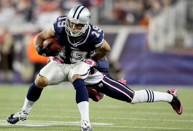 FOXBORO, MA - OCTOBER 16:  Miles Austin #19 of the Dallas Cowboys carries the ball as  Kyle Arrington #24 of the New England Patriots defends on October 16, 2011 at Gillette Stadium in Foxboro, Massachusetts. The New England Patriots defeated the Dallas Cowboys 20-16.  (Photo by Elsa/Getty Images)