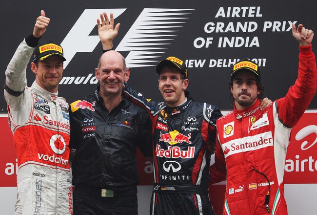 NOIDA, INDIA - OCTOBER 30:  Race winner Sebastian Vettel (2nd R) of Germany and Red Bull Racing celebrates on the podium with Red Bull Racing Chief Technical Officer Adrian Newey (2nd L), second placed Jenson Button (L) of Great Britain and McLaren and third placed Fernando Alonso (R) of Spain and Ferrari following the Indian Formula One Grand Prix at the Buddh International Circuit on October 30, 2011 in Noida, India.  (Photo by Mark Thompson/Getty Images)